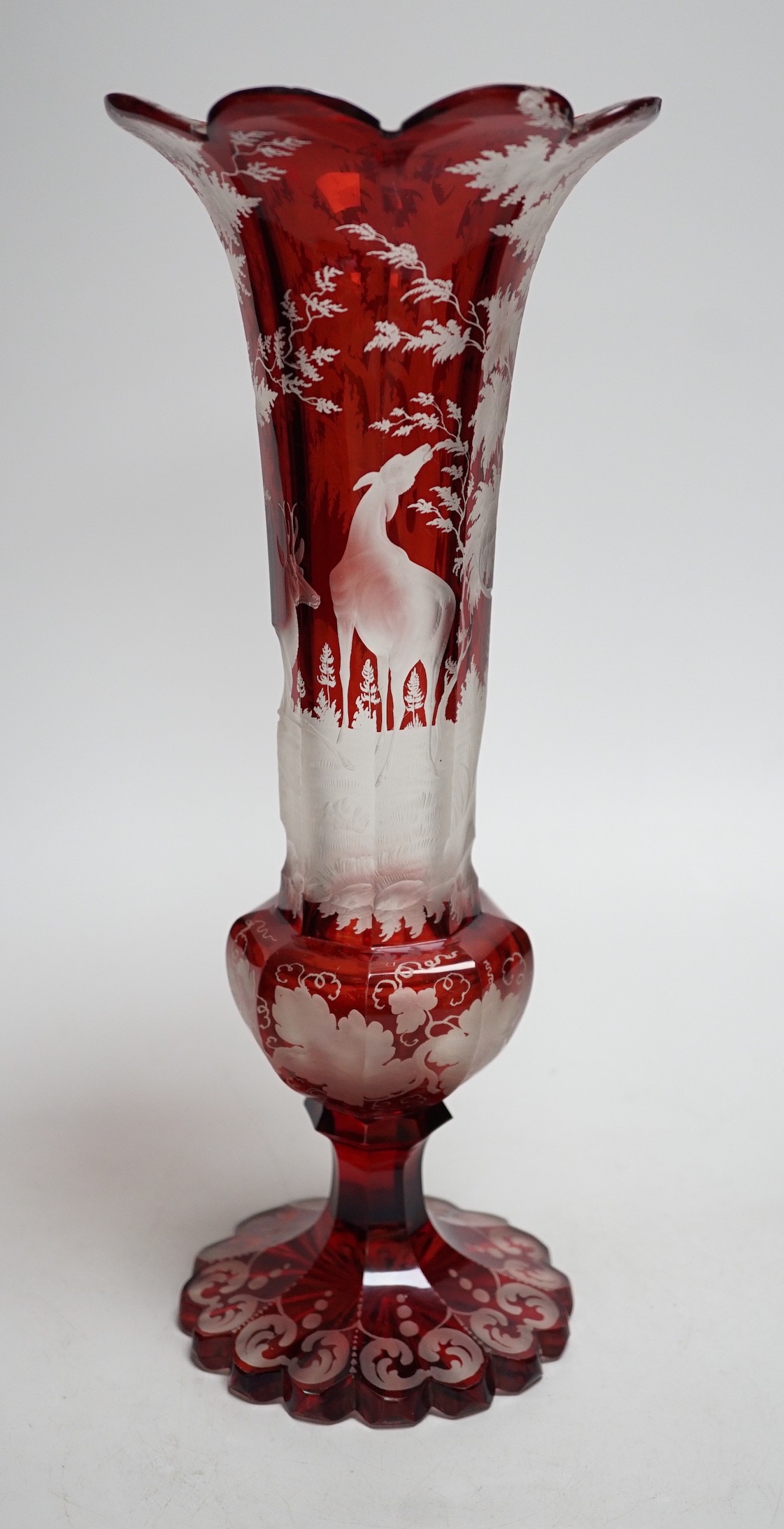 A Bohemian wheel engraved ruby glass vase (a.f.). 35cm tall